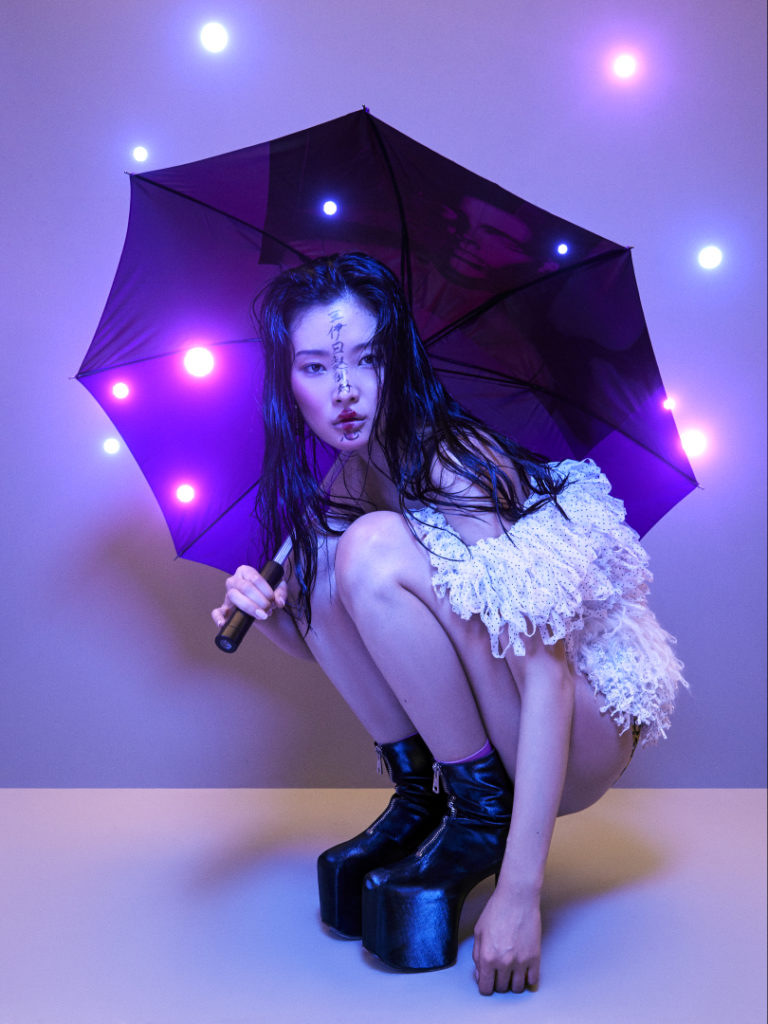 Somin wears: top CHRISTOPHER KANE. lingerie FIORUCCI. umbrella RAF SIMONS. shoes MICOL RAGNI. ART BY DHIMANTH RAO