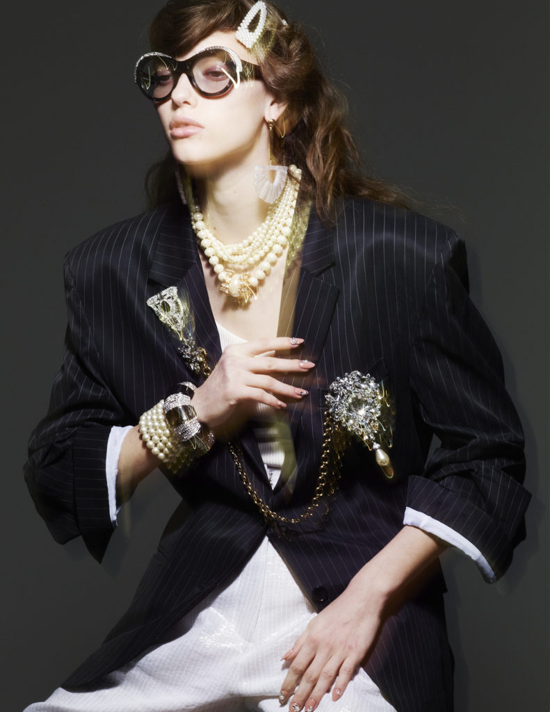 jacket MOON CHOI. bodysuit HAIGHT. pants NOON BY NOOR. hair clips and small brooch (with clear stones) RAINBOW UNICORN BIRTHDAY SURPRISE. sunglasses ALAIN MIKLI x ALEXANDRE VAUTHIER. earrings CULT GAIA. pearl choker, crystal brooch (with black stones), bracelets KENNETH JAY LANE. pearl necklace LELE SADOUGHI. chain (on jacket) MOUNSER.