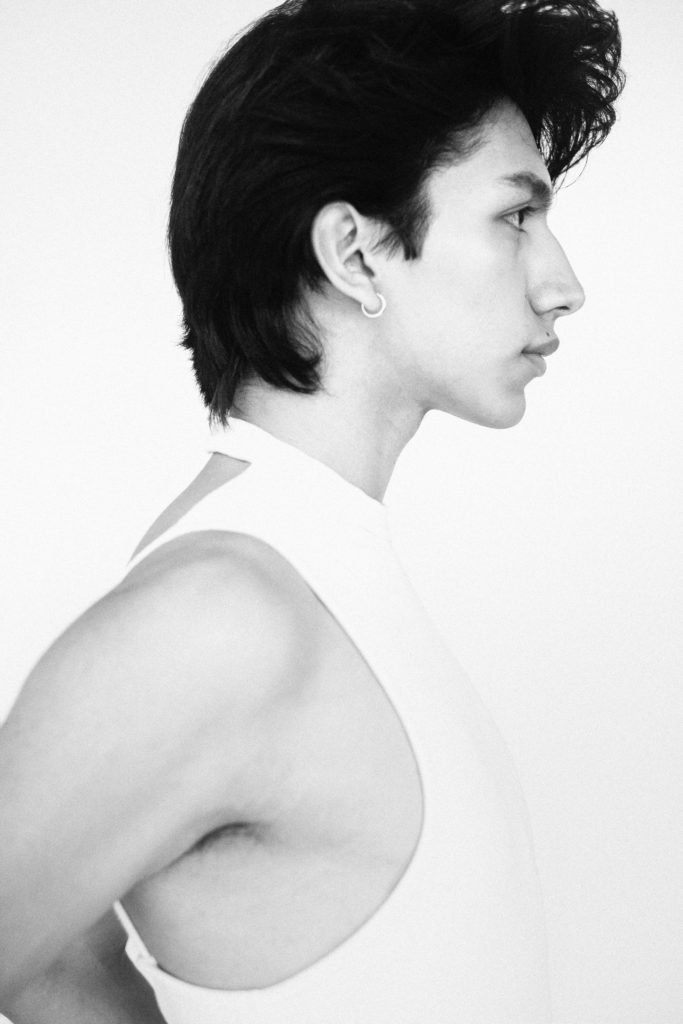 EMILIO WEARS: top TELFAR. earring his own.