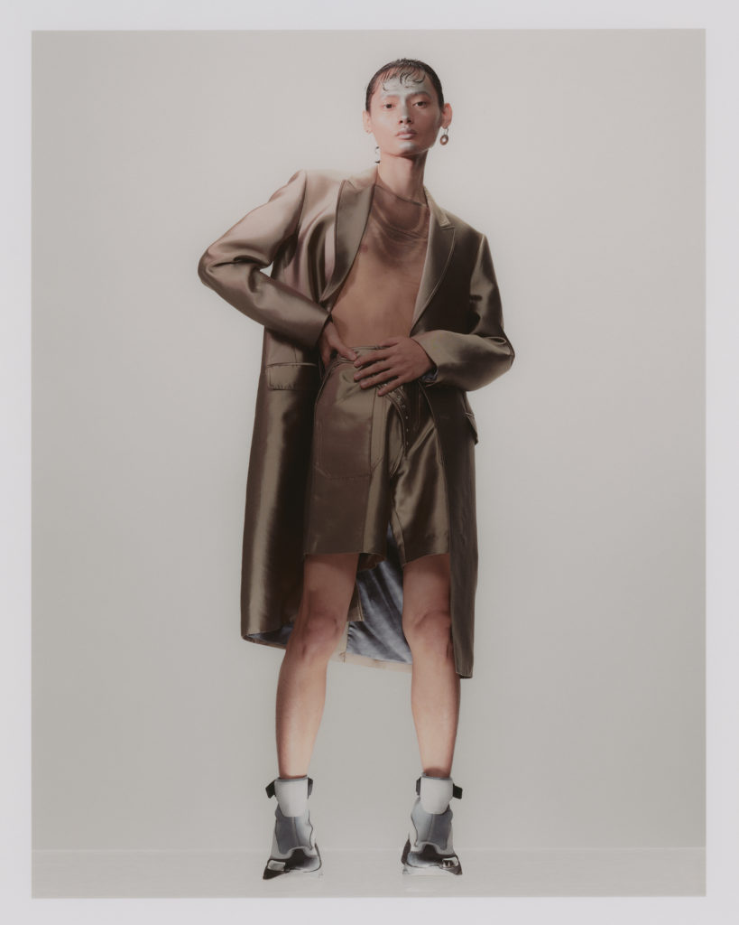 JULIAN WEARS  jacket and shorts PRIVATE POLICY. top LINDER. earring LADY GREY. shoes PALM ANGELS.