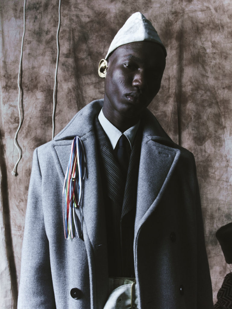 MUSA WEARS hat and belt stylist's own. coat MSGM. jacket (underneath) and shirt SALVATORE FERRAGAMO. tie CHURCH ST SURPLUS.