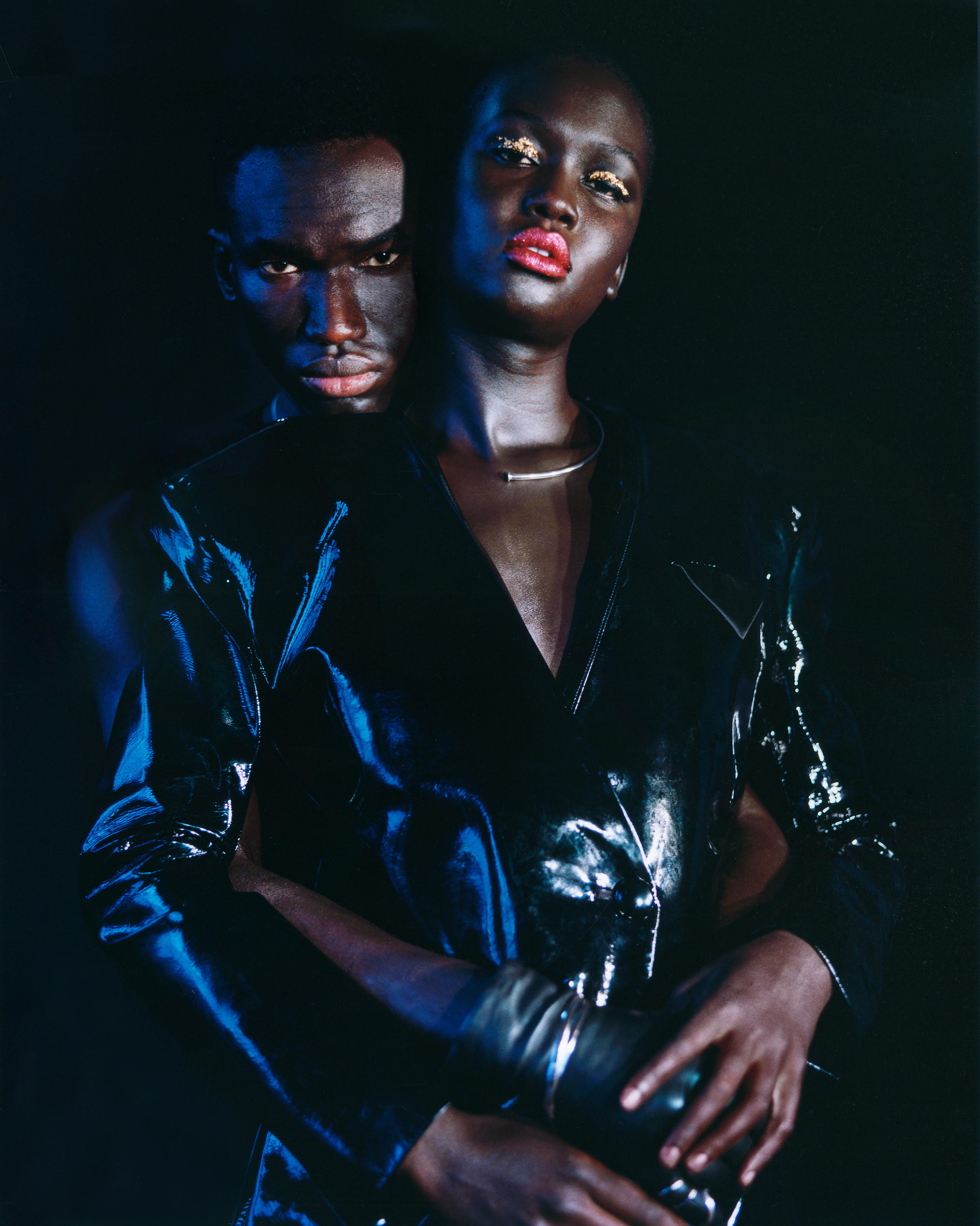 Musa wears vest and pants HOMME PLISSÉ ISSEY MIYAKE. gloves CLYDE. necklace (worn as bracelet) LADY GREY. ring PANCONESI.  Awuor wears  jacket and pants LRS. necklace BOND HARDWARE.